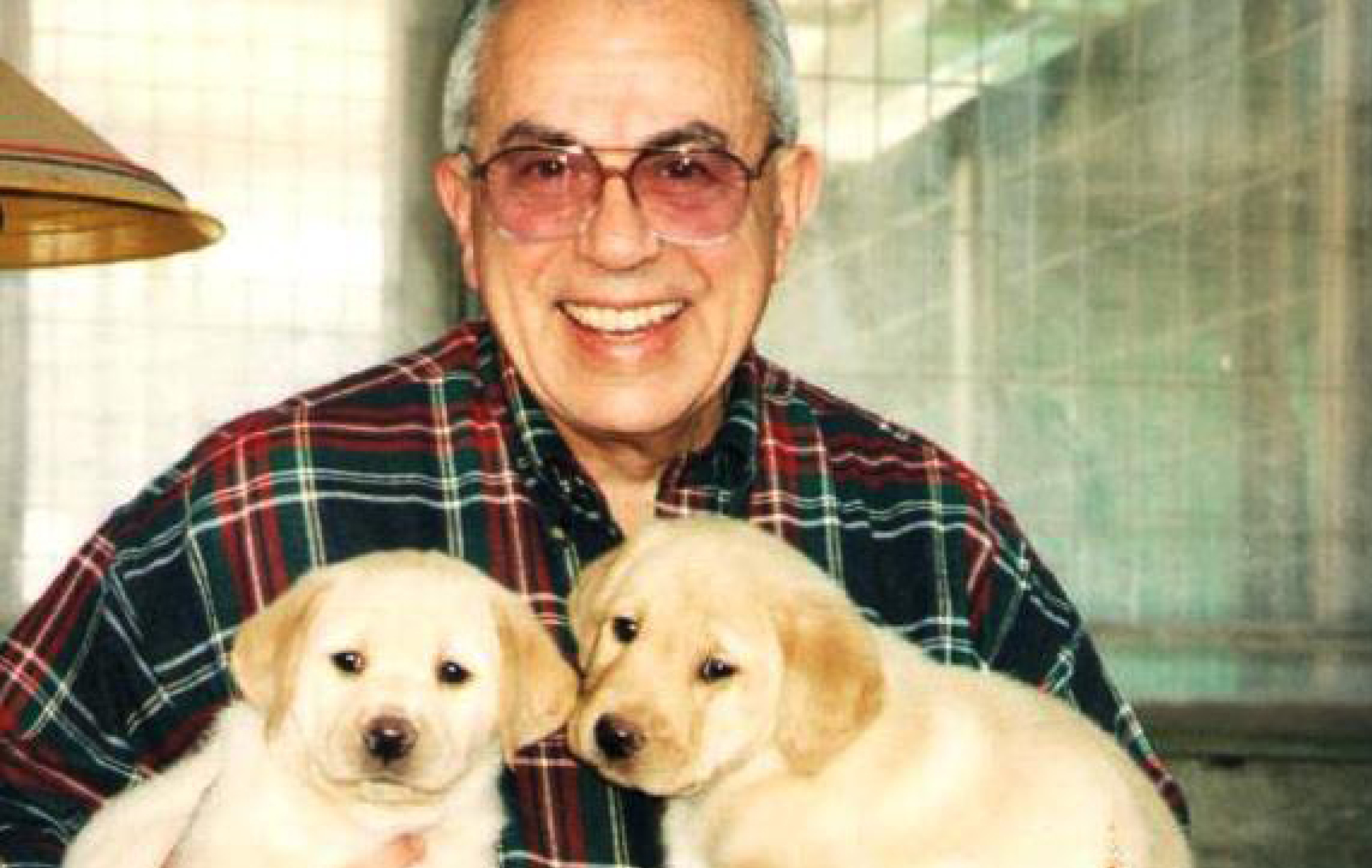 Founder, Norm Leventhal with two puppies