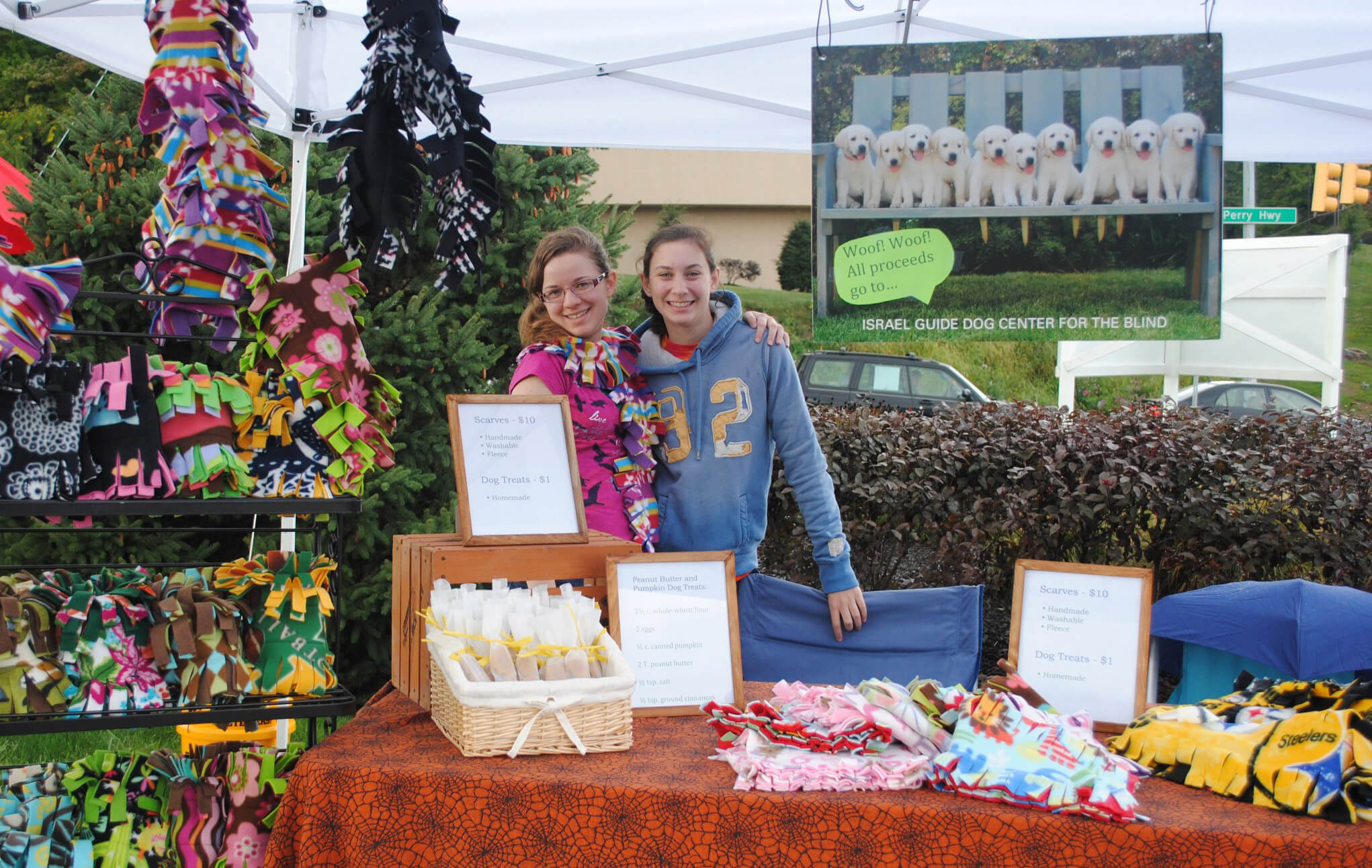 Two girls selling blankets to raise money for guide dogs